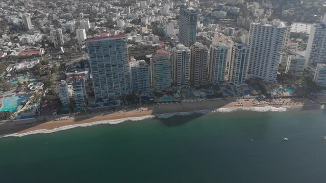 Beautiful view of the beach, aerial view of the beach, acapulco beach seen from above. Travel and vacation concept. Colorful sunset on the beach. Aerial video.