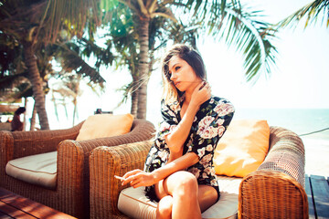 young pretty woman at swimming pool relaxing in chair, fashion look in lingerie at hotel, lifestyle...