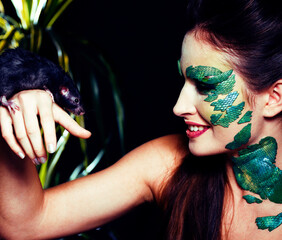 woman with creative make up like snake and rat in her hands, halloween horror closeup joke mouse