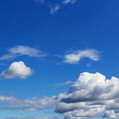 Naklejka na ściany i meble blue sky with white cumulus clouds of various sizes as a natural background
