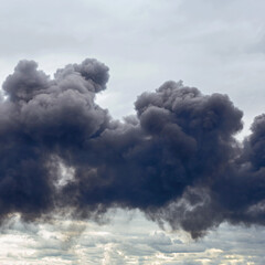 dangerous cloud of black smoke close up as background