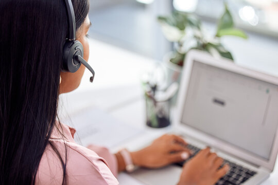 If theres a problem, well a.find a the solution. Shot of a businesswoman wearing a headset while working on her laptop.
