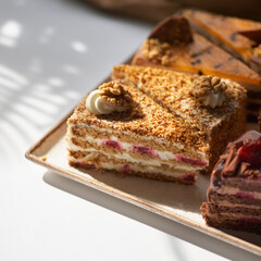 Assortment of pieces of cake on plate, copy space. Several slices of delicious desserts, restaurant menu concept, top view