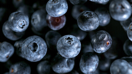 Flying and Rotating Fresh Blueberries, close-up.