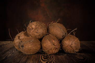 Coconut pieces isolated on wooden background, close-up