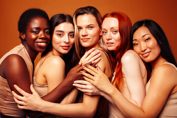 Obraz premium young pretty caucasian, african, scandinavian woman posing cheerful together on brown background, lifestyle diverse nationality people concept