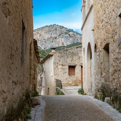 Saint-Guilhem-le-Desert in France, view of the village, typical street and houses
