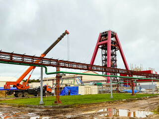 Fototapeta na wymiar construction site. in the mine there is a metal, large, red underground crane. extraction of mining minerals. use of natural resources