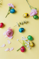 Easter eggs, flowers on yellow background
