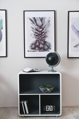 Stylish interior of minimalist room with shelf unit and decor