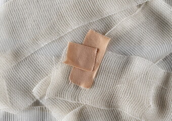 Adhesive bandage on medical bandage background and texture, top view