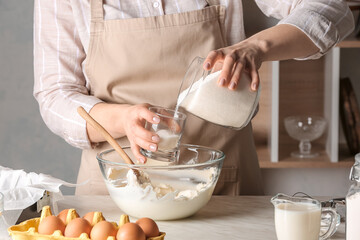 Woman preparing tasty Basque burnt cheesecake in kitchen