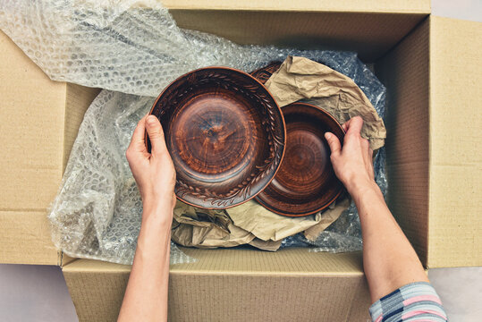 Delivery package of goods dishes in a cardboard box top view.