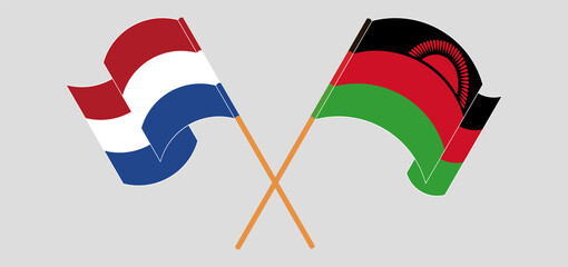Crossed and waving flags of the Netherlands and Malawi