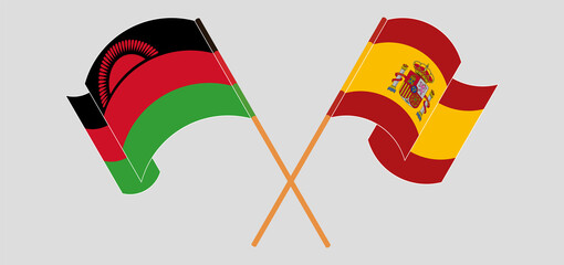 Crossed and waving flags of Malawi and Spain