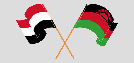 Crossed and waving flags of Yemen and Malawi