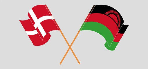 Crossed and waving flags of Denmark and Malawi