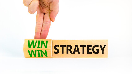 Win-win strategy symbol. Businessman turns wooden cubes with words win win strategy. Beautiful white table, white background. Business, win-win strategy concept. Copy space.