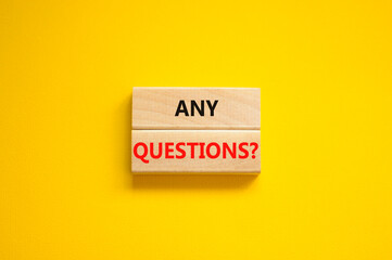 Any questions symbol. Concept words Any questions on wooden blocks on a beautiful yellow table yellow background. Business and Any questions Q and A concept, copy space.