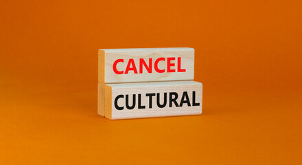 Cancel cultural symbol. Concept words Cancel cultural on wooden blocks on a beautiful orange table orange background. Business and cancel cultural concept, copy space.