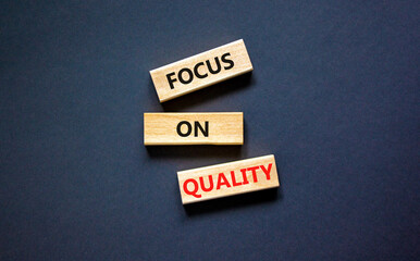 Focus on quality symbol. Concept words Focus on quality on blocks on beautiful black table black background. Business, focus on quality concept. Copy space.