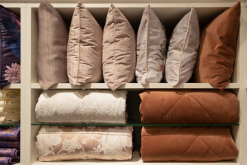 Blankets and pillows in the store. Neatly laid out on the shelves