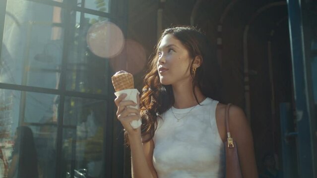 Smiling Woman Enjoying Ice Cream Outdoors. Brunette Asian Lady Eating Dessert.