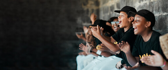 Cheering on their team. Cropped shot of a group of young baseball players cheering and supporting their team from the bench during a game.