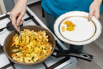 woman putting pieces of fried chicken on a plate