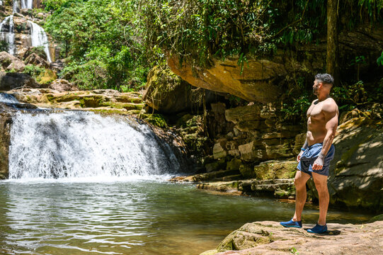 Tourist looking at the Bayoz Waterfall, in Puerto Yurinaki, it is among the most beautiful in the