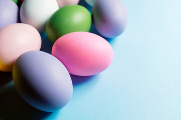 Banner. Easter eggs on a blue background. Card with copy space for the text. Colorful Easter Eggs. Happy Easter! Spring holidays concept. Flat lay of cute pastel and colorful easter eggs.