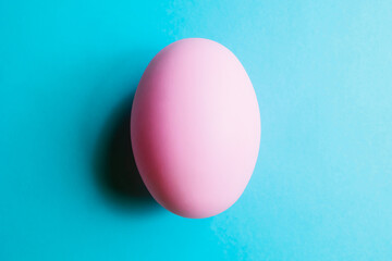Easter egg isolated on a blue background, close-up. Pink easter egg with clipping path.
Top view of isolated pink pastel colored egg. Minimal concept. Happy Easter concept.