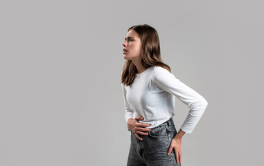 Girl having a stomachache. Young woman suffering from abdominal pain. Woman Stomach Ache. Woman touching his stomach. Stomach pain and others stomach disease concep - obrazy, fototapety, plakaty