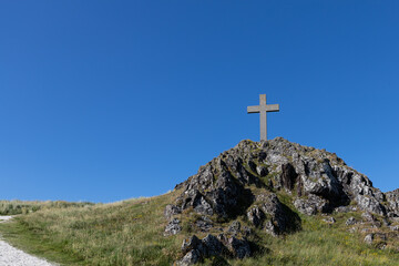 Stone Cross Against Blue Sky in Llanddwyn Island, Anglesey, North Wales, UK.