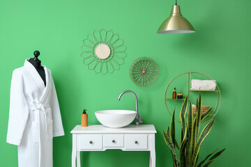 Interior of stylish bathroom with white table, sink and mannequin