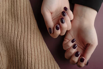 Fototapeten Woman showing her beautiful  manicure near a beige wool material. Trendy square nails Manicure. Manicure beauty salon concept. Hands after getting professional manicure in beauty salon, closeup. © Antonie