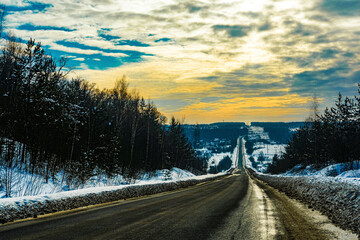 Landscape with the image of winter road at sunset in Tarusa, Russia