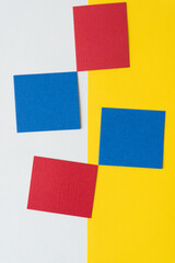 red and blue squares on white and yellow paper