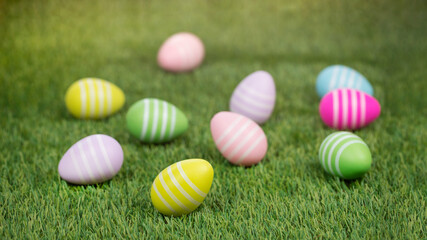 Fototapeta na wymiar Easter eggs ready for egg hunting in sunlight on green grass