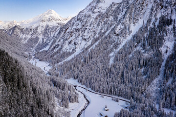 Snow-covered forest road. Forest road from above. Aerial winter landscape