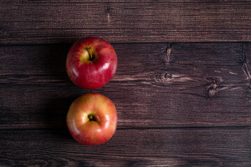 two ripe apples on a brown wooden background.top view.