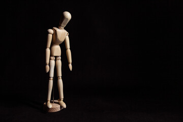 Sad wooden mannequin with his head lowered. Symbol of depression and breakdown