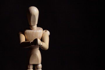 Wooden mannequin with folded hands. Symbol of prayer and religiosity