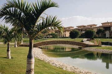 New Cairo, Egypt - 11.21.2021: Beautiful lake and bridge at villas area at Madinaty compound, luxury living in Egypt