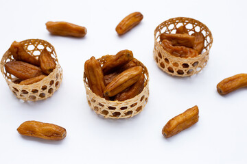 Sun-dried bananas on white background.