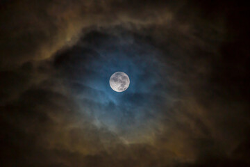 Naklejka na ściany i meble The eye in the sky: Full moon surrounded by skies