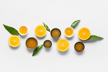 Composition with tasty orange jam and leaves on blue background