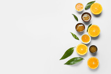 Composition with tasty orange jam and leaves on blue background