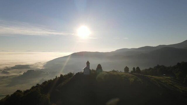 Beautiful sunrise shoot rotating Drone shoot,moody green, green woods, clouds, sunrise , sunny day, woods, afternoon Europa SLOVENIJA, Ljubljana, prodia, from back, church religion vol.3