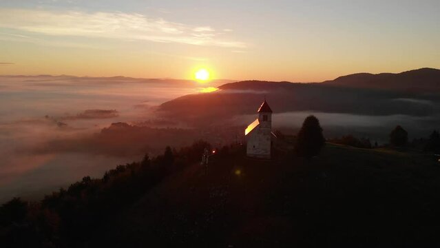 Beautiful sunrise shoot Drone shoot,moody green, green woods, clouds, sunrise , sunny day, woods, afternoon Europa SLOVENIJA, Ljubljana, prodia, from back, church religion sun